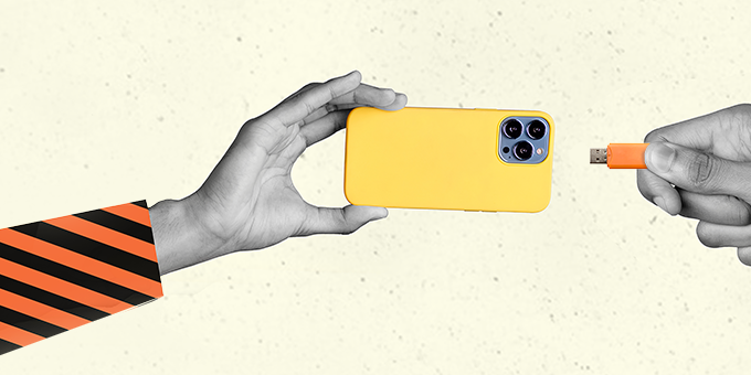 One hand with a phone handing it to another hand